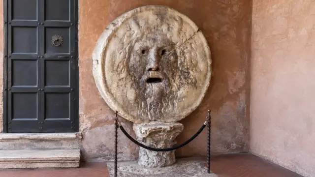 Marble disc carved with a bearded face and an open mouth in the portico of Santa Maria in Cosmedin, Rome