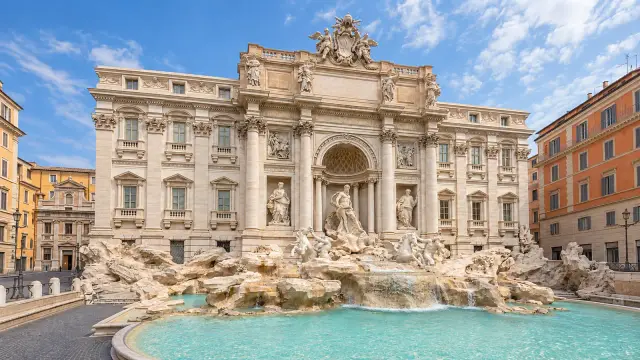 The Trevi Fountain from the front, with its statues and the water of the basin in the foreground, Rome