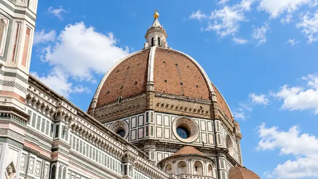 The red-tiled dome of Florence Cathedral, with white ribs and the marble lantern on top