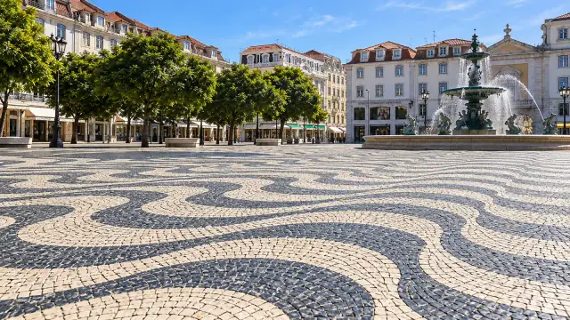 Black-and-white waves of Portuguese calçada paving in Rossio Square, Lisbon